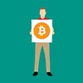 person holding bitcoin board